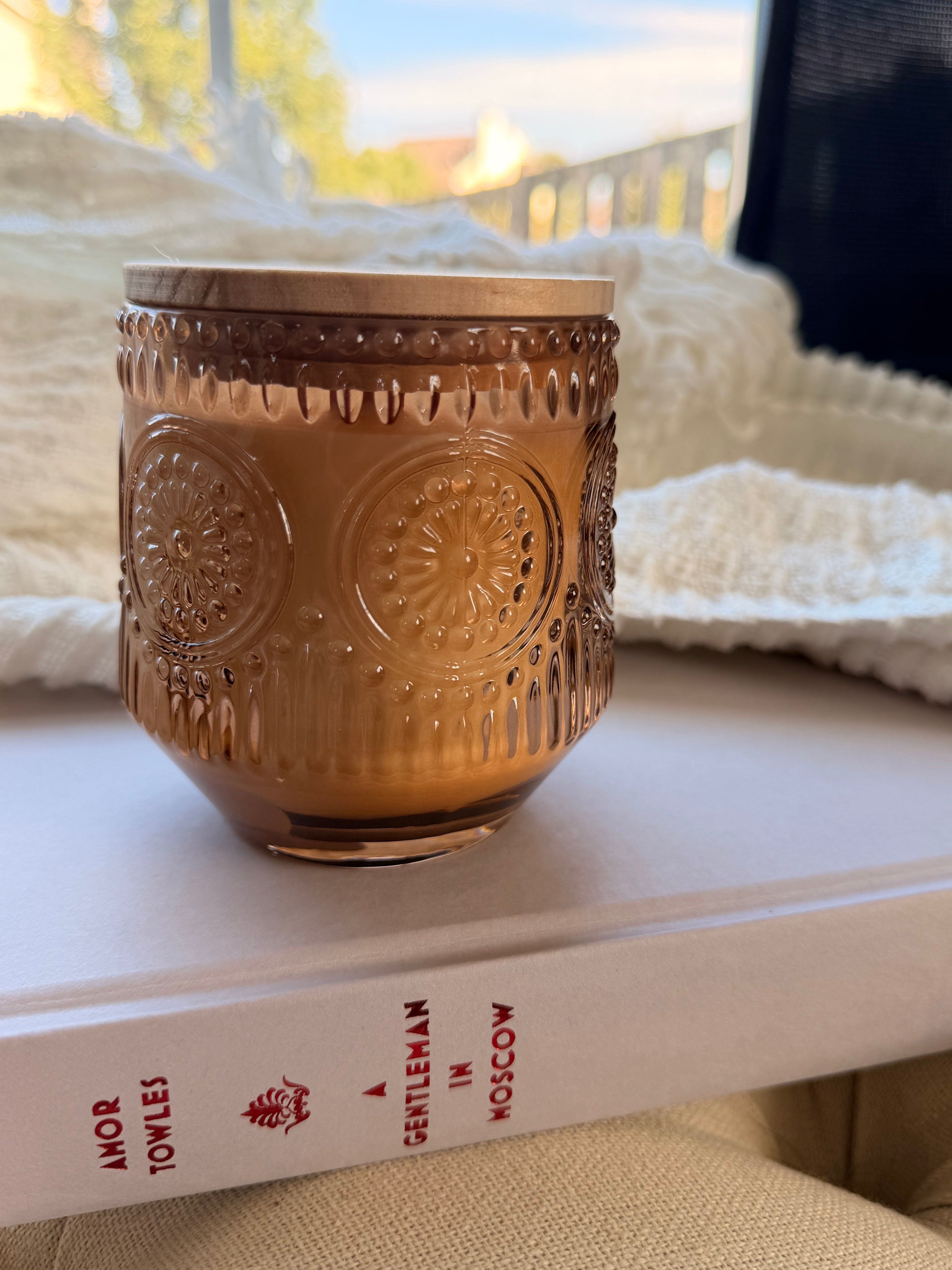 Pumpkin Praline candle in embossed brown glass jar with wood lid
